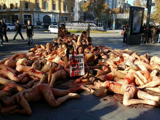 Naked ambition: Animal rights activists strip down to light up fur industry